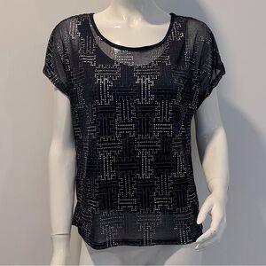 Unlabeled. Sheer Lined Top.
Round neckline and dolman short sleeves.